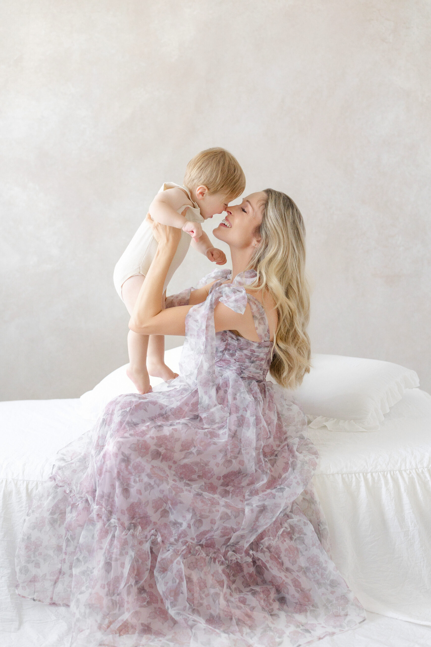 Mom and baby cuddling during a natural light studio session in Tampa FL